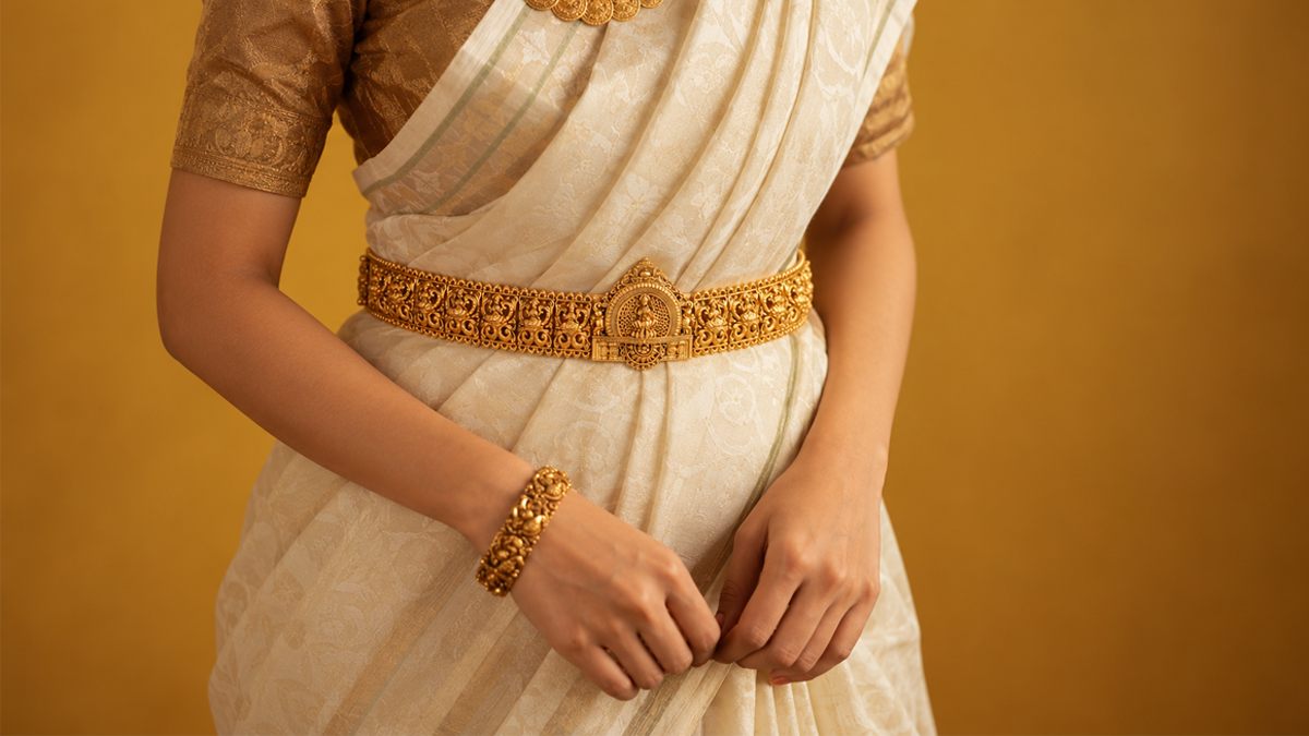 Temple oddiyanam hip belt worn over a silk saree, in gold-plated 925 silver - Vilva Jewels Madurai